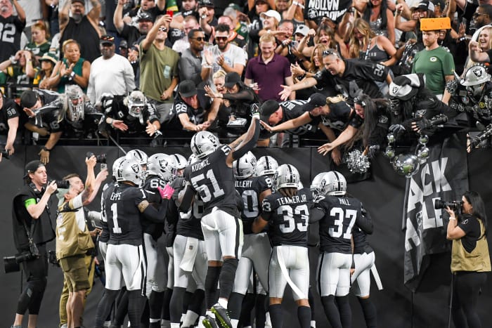 Players from the Las Vegas Raiders celebrate with their fans inside Allegiant Stadium.